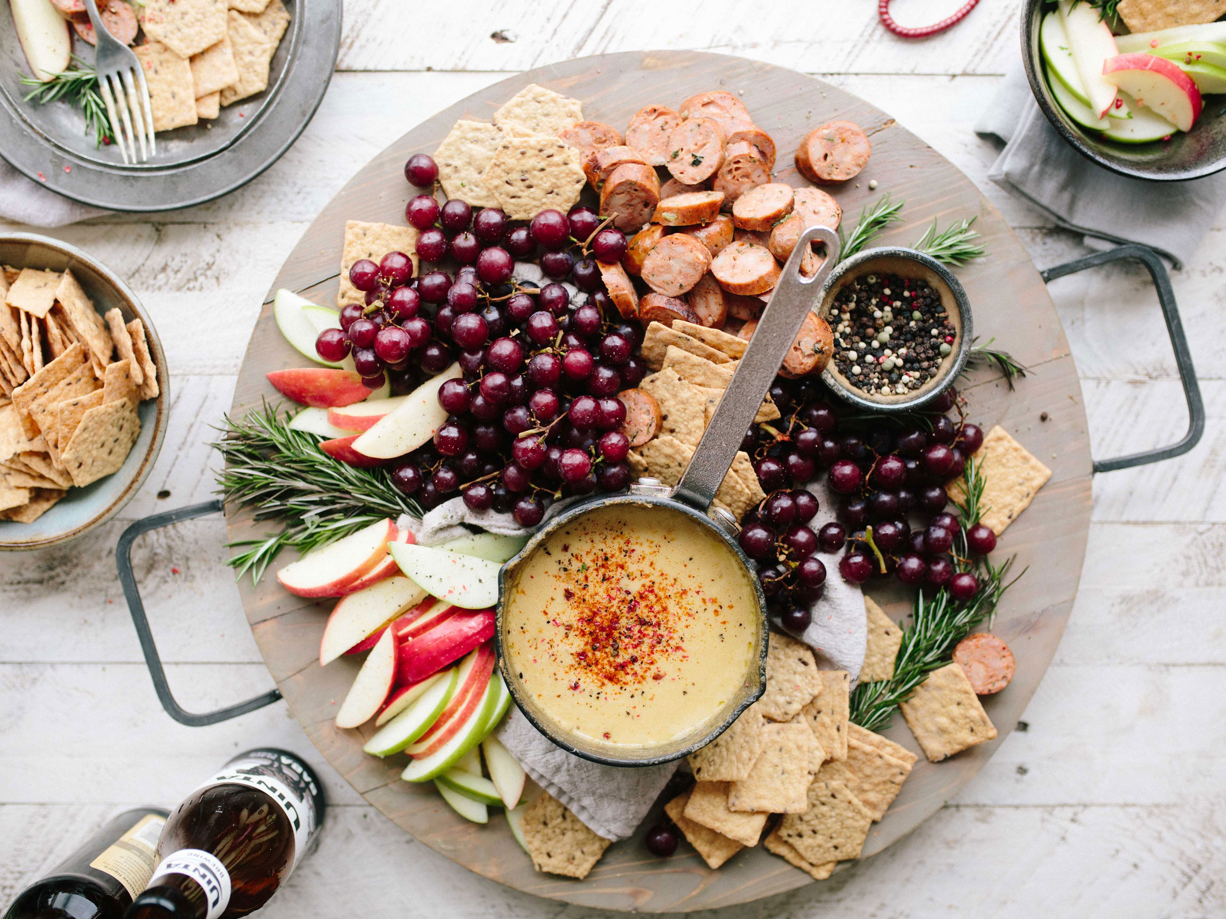 A colorful catered spread with fruit, crackers, and dip